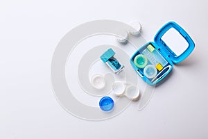 Composition with contact lenses and accessories on white background