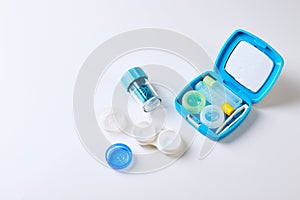 Composition with contact lenses and accessories on white background