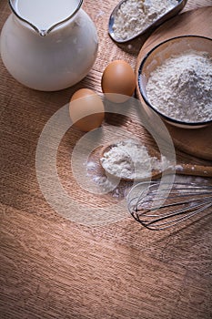 Composition corolla eggs flour in bowl and spoon