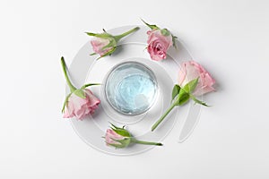 Composition with cosmetic gel and flowers on white background, top view