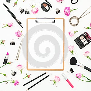Composition with cosmetics clipboard, accessories and pink roses on white background. Top view. Flat lay. Beauty blog background