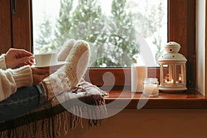 Composition of cozy winter day on wooden windowsill