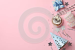 Composition with cupcake and birthday accessories on pink background