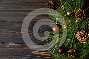 Composition with decorated Christmas tree on dark rustic wooden background