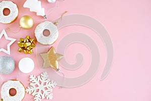 Composition decoration of snowflakes, stars, balls, donuts of gold, white and silver color on a pink