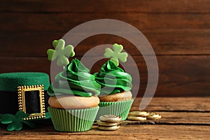 Composition with delicious decorated cupcakes on table, space for text. St. Patrick`s Day celebration