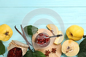 Composition with delicious quince jam and fruits on light blue wooden table, flat lay. Space for text