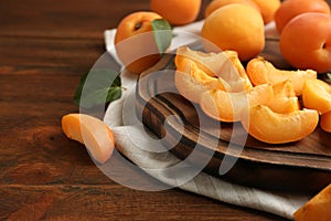 Composition with delicious ripe sweet apricots on wooden table