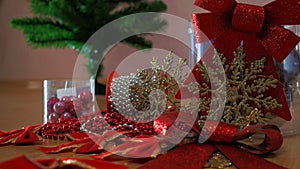 Composition design. Christmas Ball, Ribbon Bows, Plastic Glitter Christmas Snowflakes Ornaments. Mans Hand Decorating