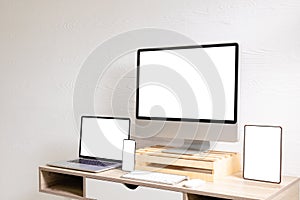 Composition of desktop computer, laptop, tablet and smartphone with copy space on white background