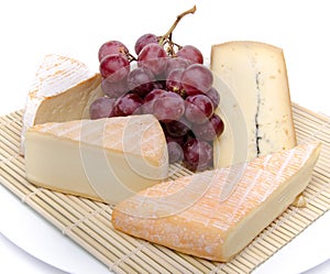 Composition of different cheeses on a straw placemat