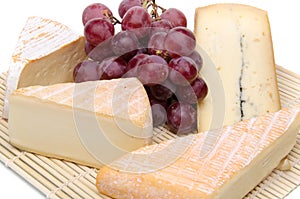 Composition of different cheeses on a straw placemat