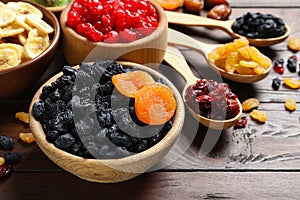 Composition with different dried fruits on wooden background
