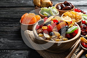 Composition with different dried fruits on wooden background. Healthy lifestyle