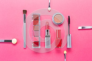 Composition with different makeup products on pink background, top view. beauty products and fashion concept