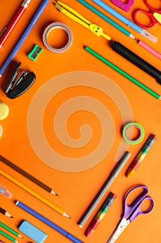 Composition with different school stationery on color background