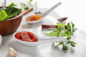 Composition with different spices and herbs on white wooden background