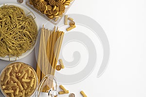 Composition of different types of dry and boiled pasta and spaghetti on a white background. Banner with copy space for text. A set