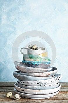 Composition with dinnerware on table against light background, space for text.
