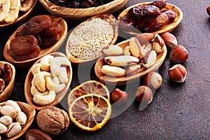 Composition with dried fruits and assorted healthy nuts in wooden bowls