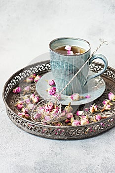 Rose buds tea, tea cup, strainer  with rosebuds on  vintage tray