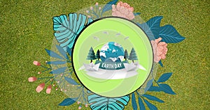 Composition of earth day text and logo with leaves on green background