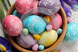 Composition with Easter eggs and Iris flowers on wooden background