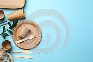 Composition with eco - friendly tableware and plant on blue background