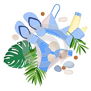 A composition of elements of a beach holiday: a swimsuit, flip-flops, tropical leaves, sea stones and shells, bottles of sunscreen