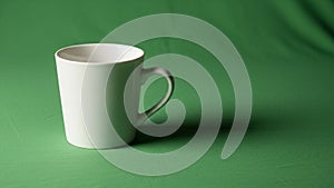 Composition emphasizes the contrast between the cup s whiteness and the