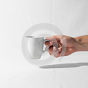 The composition emphasizes the simplicity and functionality of the mug