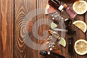 Composition with essential oils and citrus fruits on wooden background