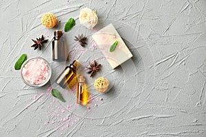 Composition with essential oils and soap on textured background, top view