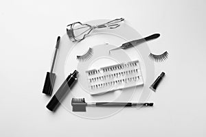 Composition with false eyelashes and tools on white background, top