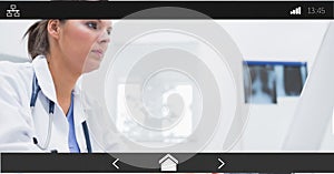 Composition of female doctor using computer on digital image interface screen