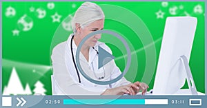 Composition of female doctor using coputer on video playback interface screen