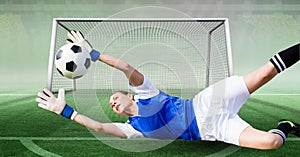 Composition of female goalkeeper catching ball at football stadium