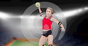 Composition of female volleyball player jumping throwing ball over blurred indoor court background