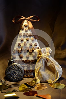 Composition for festive background with gift, clock and coffe tree on dark background vertically