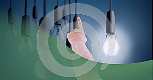 Composition of finger touching screen with lightbulbs on blue background