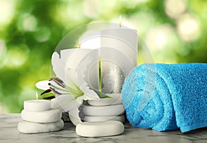 Composition with flower and spa supplies marble on table against blurred green background