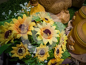 Composition of flowers and ceramics. A bouquet of bright yellow sunflowers