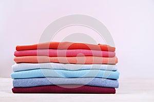 Composition with folded clothes, unisex for both man and woman, different color & material. Pile of laundry, dry clean clothing