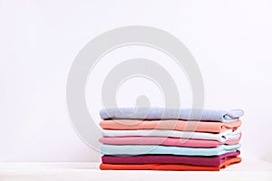 Composition with folded clothes, unisex for both man and woman, different color & material. Pile of laundry, dry clean clothing