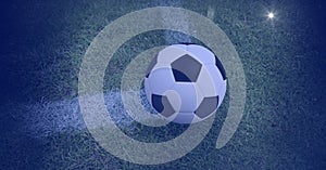 Composition of football on white line on grass pitch