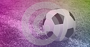 Composition of football on white line on grass pitch with copy space and pink tint
