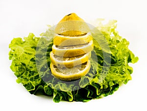Composition of fresh and cut lemons on salad on white background