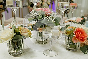 Composition of fresh flowers on a festive wedding table. Elegance wedding decor.