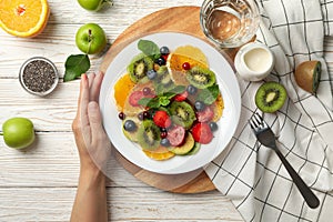 Composition fresh fruit salad on white wooden table, top view