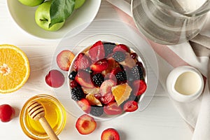 Composition fresh fruit salad on white wooden table, top view